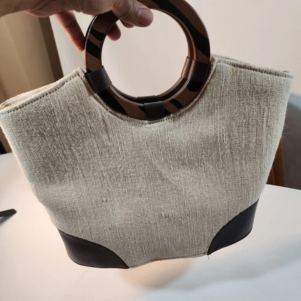 Beige Woven Handbag With Brown Accent at Bottom and Brown Decorative Wood handle
